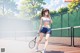 A woman standing on a tennis court holding a tennis racket.