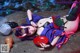 A woman laying on a rock next to a bowl of food.